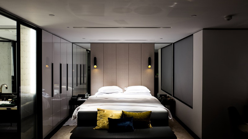 “Modern bedroom interior design in Hyderabad with elegant furnishings and warm lighting.”
